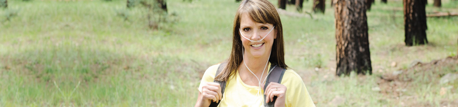 Woman wearing backpack and oxygen equipment while hiking in Cincinnati