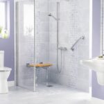 Purple bathroom with toilet, shower, and sink with different types of bathroom safety equipment